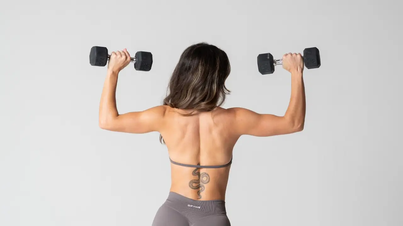 Kennedy Fit lifting two dumbbells